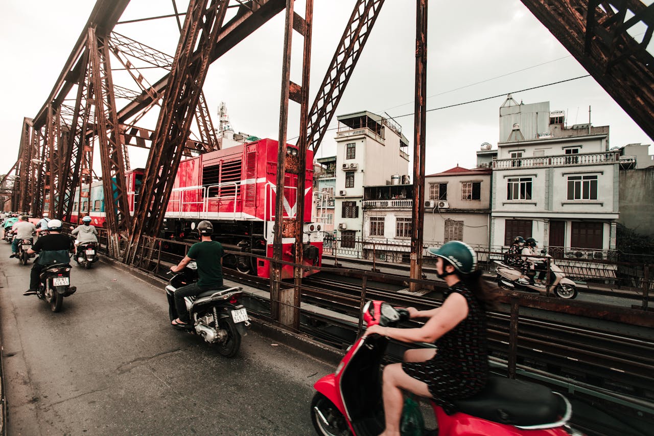 services-03 Dynamic view of traffic and train crossing a bridge in Hanoi, Vietnam.